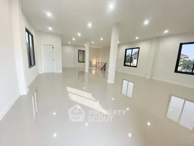 Spacious modern living room with glossy tile flooring and large windows.