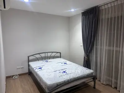 Modern bedroom with metal bed frame and elegant curtains