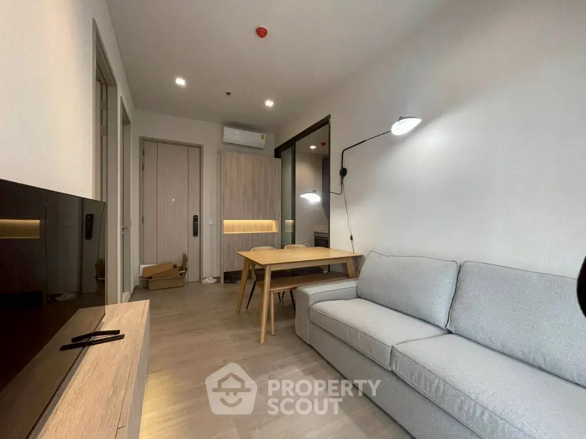 Modern living room with sleek furniture and ambient lighting, perfect for cozy relaxation.