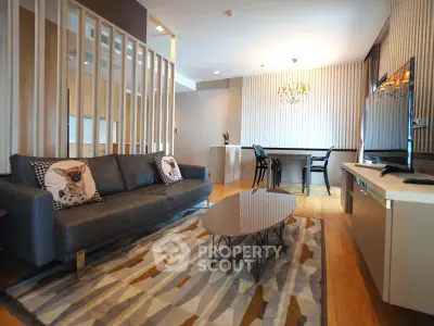 Modern living room with stylish decor and open layout, featuring a cozy sofa and elegant dining area.