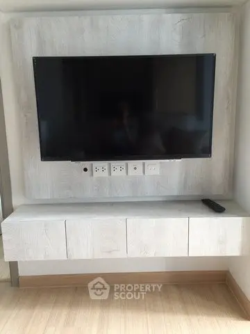 Modern living room with wall-mounted TV and sleek cabinetry