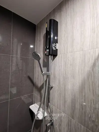Modern bathroom with sleek shower and dark tile design