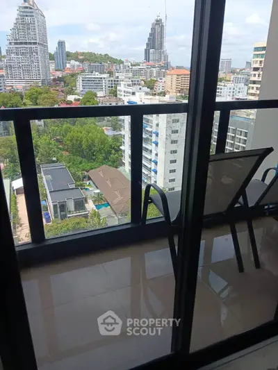 Stunning high-rise balcony view overlooking cityscape and lush greenery, perfect for urban living.