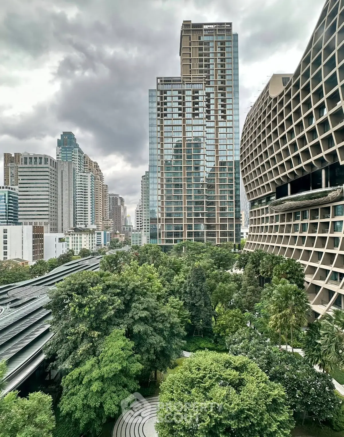 Stunning urban view with modern skyscrapers and lush greenery in a vibrant cityscape.