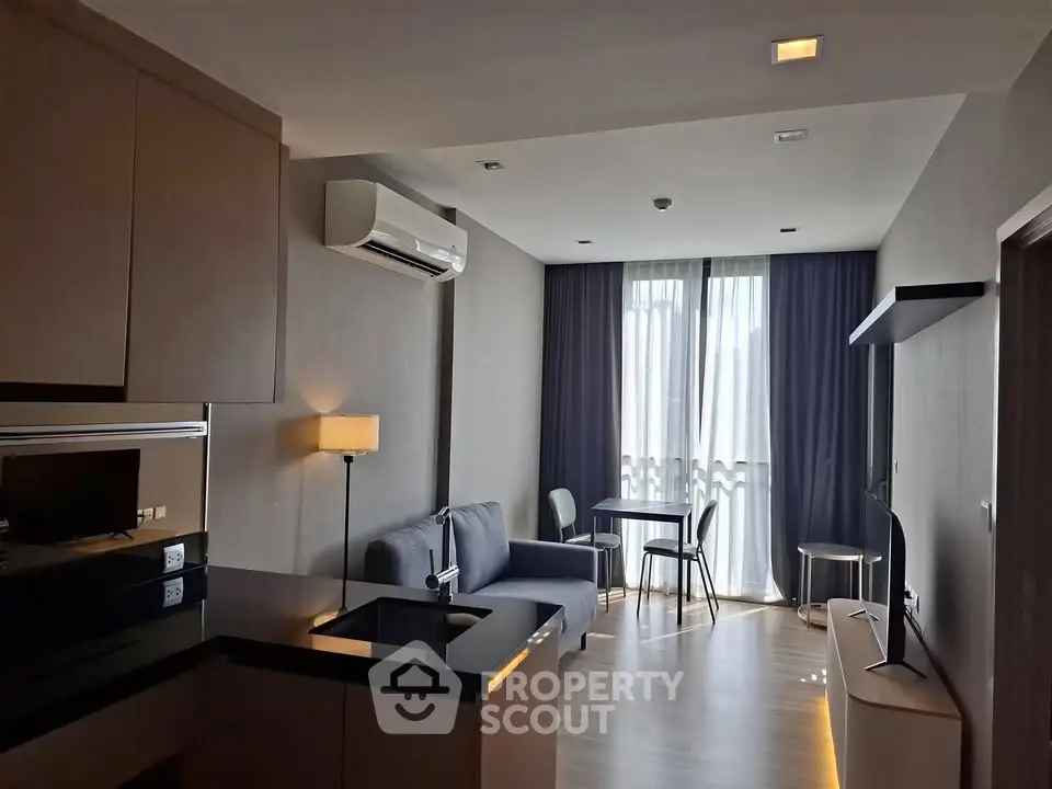Modern living room with sleek furniture and natural light in a stylish apartment.