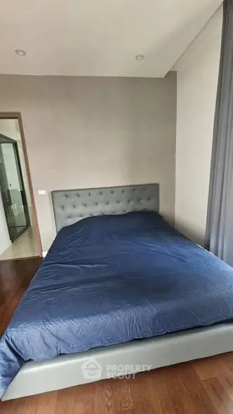 Modern bedroom with stylish bed and elegant decor in a contemporary apartment.