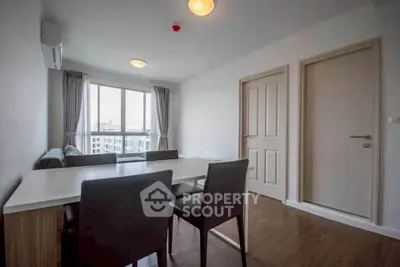 Modern living room with dining area and large window view