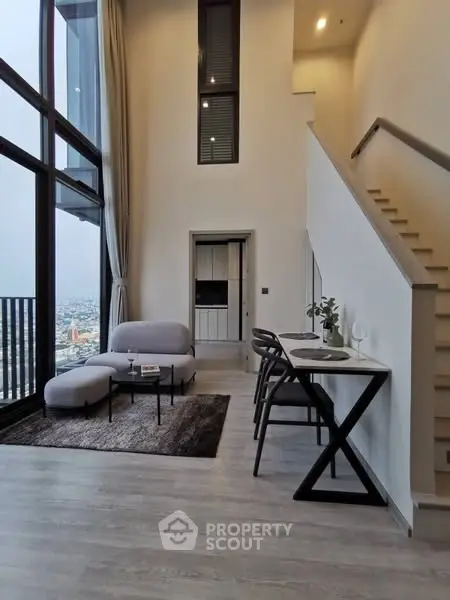 Modern duplex living room with high ceilings and city view