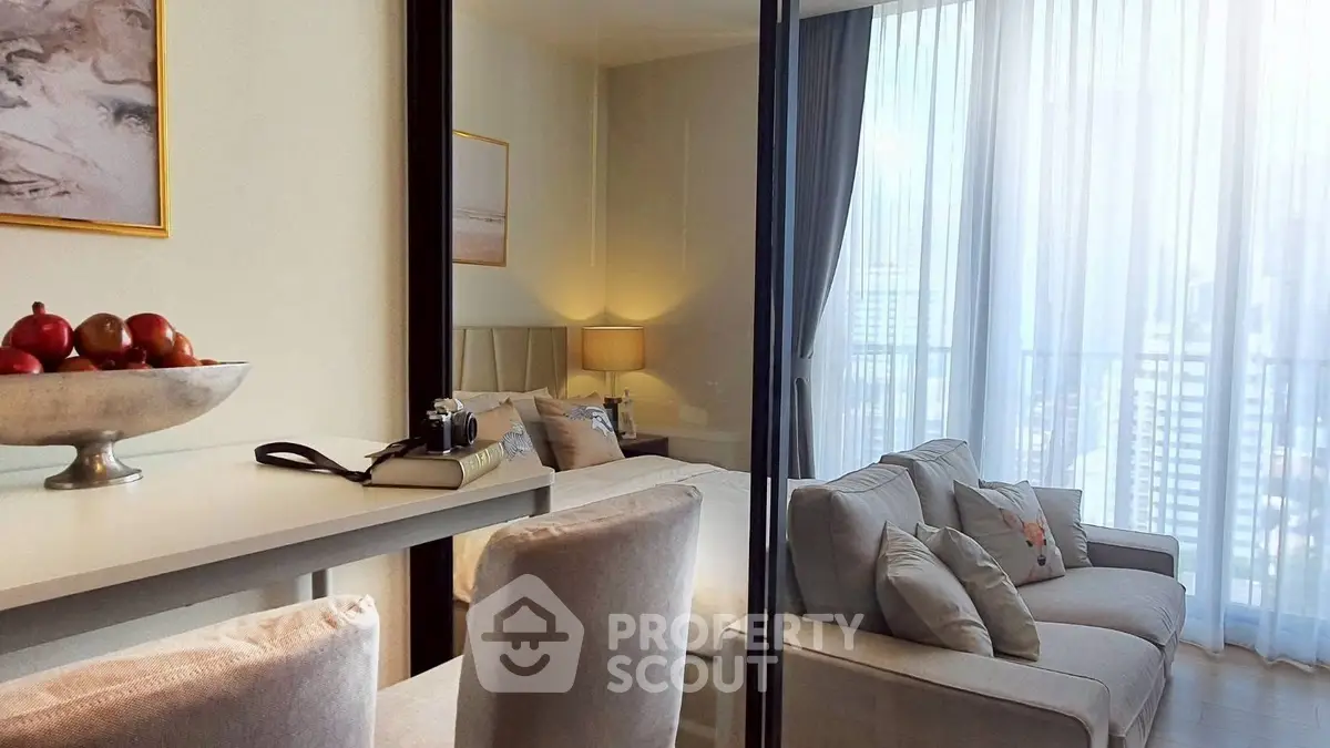 Modern living room with elegant decor and city view through large windows.