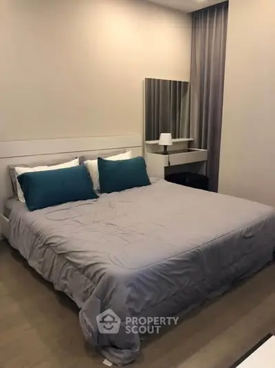 Cozy bedroom with modern decor and plush bedding in a stylish apartment.