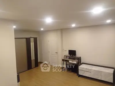 Spacious modern living room with wooden flooring and sleek furniture