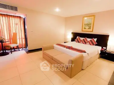 Spacious bedroom with elegant decor and cozy seating area