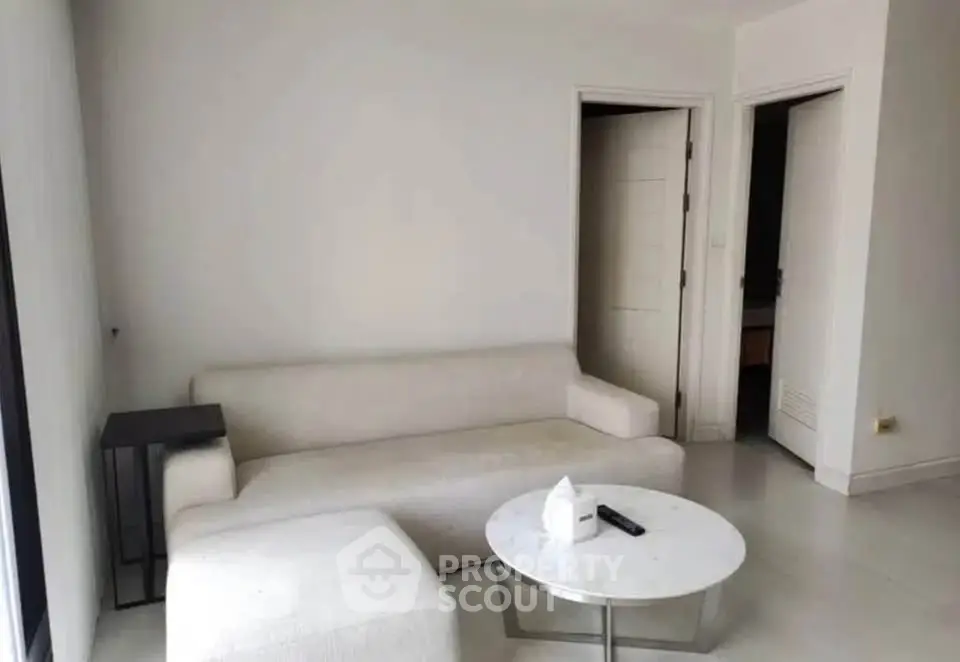 Modern minimalist living room with white sofa and sleek coffee table