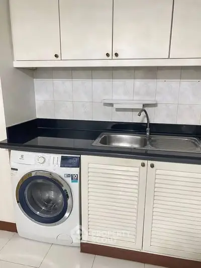 Modern kitchen with built-in washing machine and sleek cabinetry