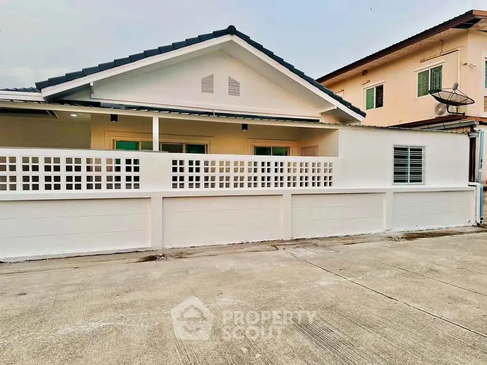 Charming single-story home with modern facade and spacious driveway