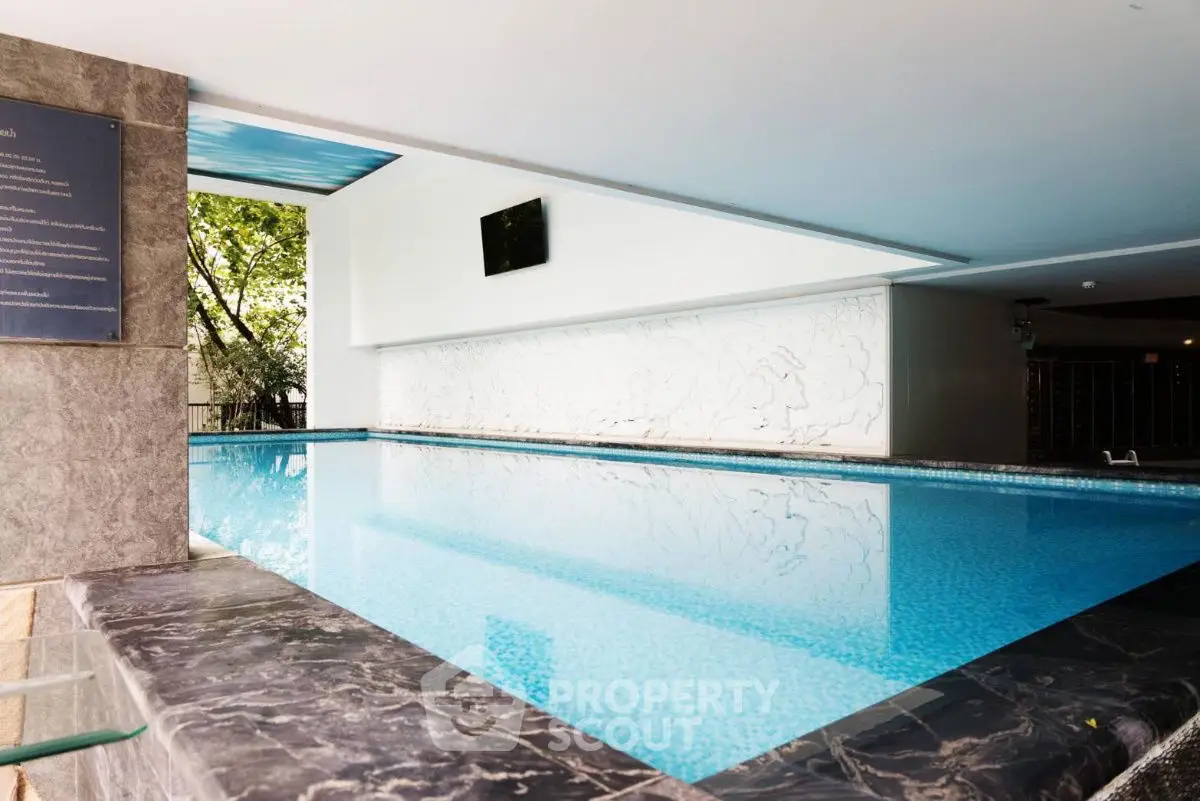 Luxurious indoor pool with modern design and elegant marble accents