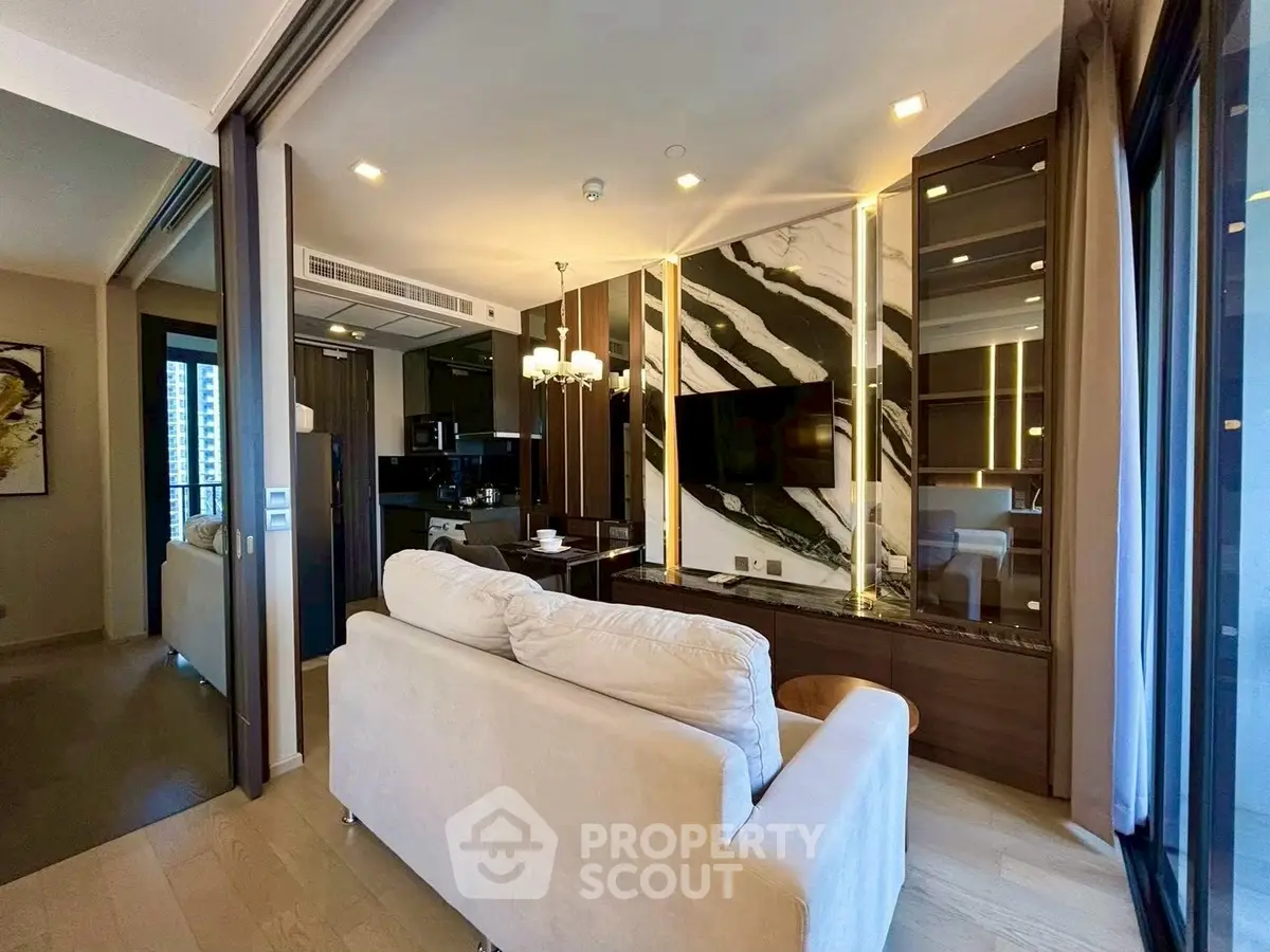 Luxurious modern living room with elegant marble accents and cozy seating area.