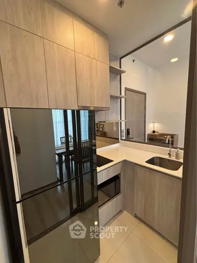 Modern kitchen with sleek cabinetry and built-in appliances in a compact layout.