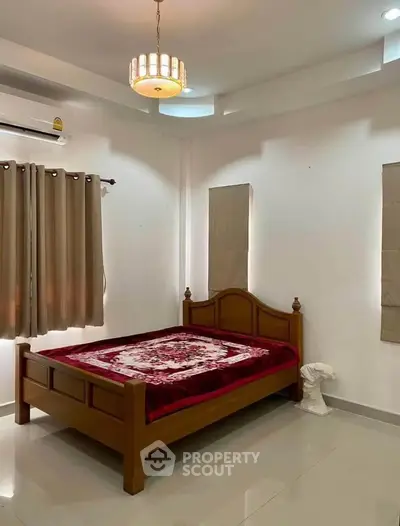 Cozy bedroom with wooden bed and elegant lighting, perfect for relaxation.