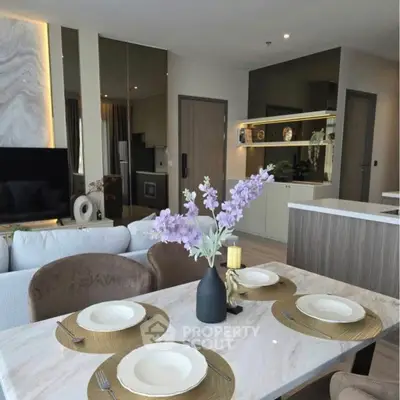 Modern open-plan living and dining area with elegant decor and stylish furniture.