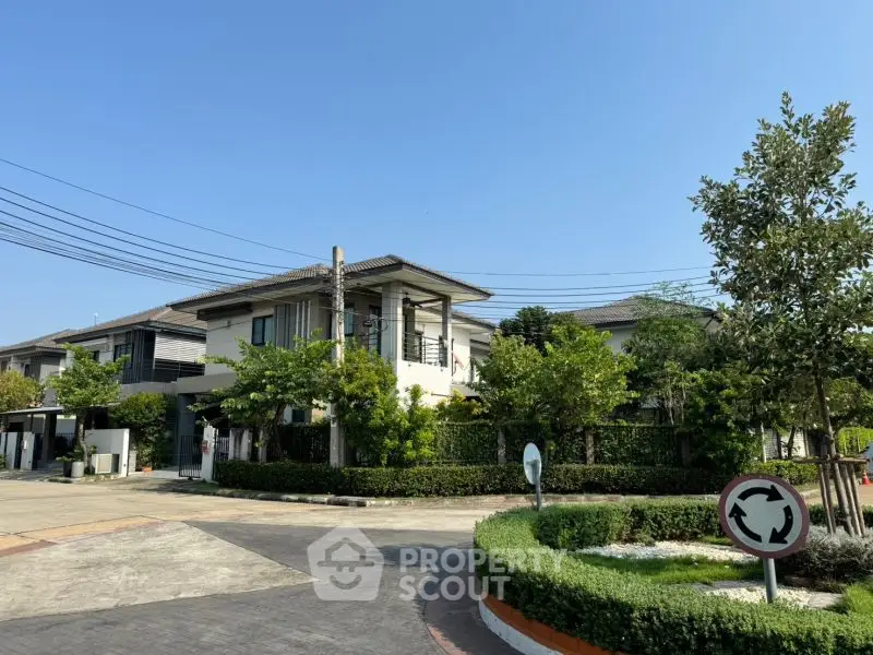 Charming suburban house with lush greenery and modern architecture in a peaceful neighborhood.