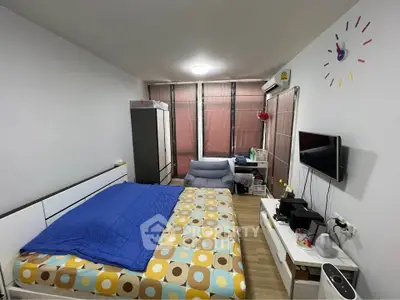 Modern bedroom with stylish decor and ample natural light from large windows.