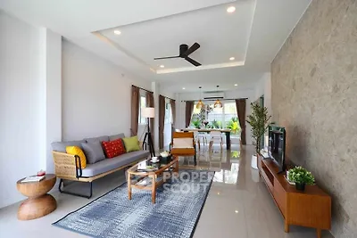 Spacious modern living room with stylish decor and open layout, perfect for entertaining.