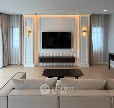 Elegant living room with modern TV setup and stylish lighting, perfect for relaxation and entertainment.