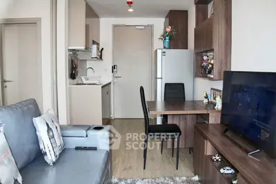 Modern compact apartment with open kitchen and cozy living area, featuring stylish furniture and decor.