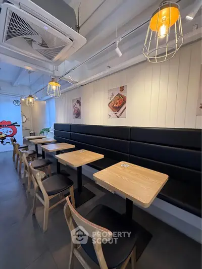 Chic modern cafe interior with wooden tables and stylish lighting