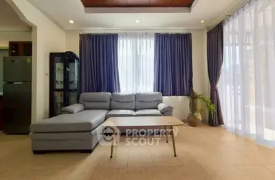 Spacious living room with modern sofa and large windows for natural light