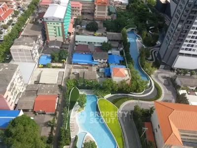Stunning aerial view of modern residential complex with winding pool and lush greenery