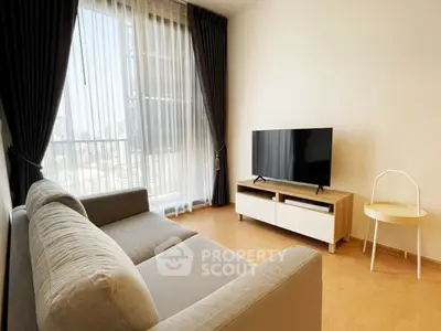 Modern living room with large window and stylish furniture