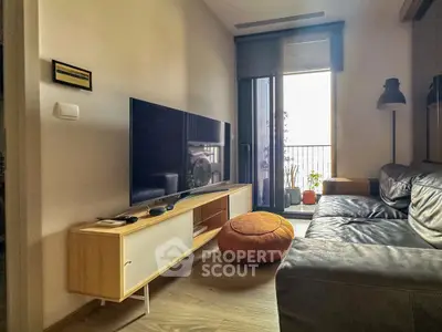 Modern living room with sleek TV setup and cozy seating area.