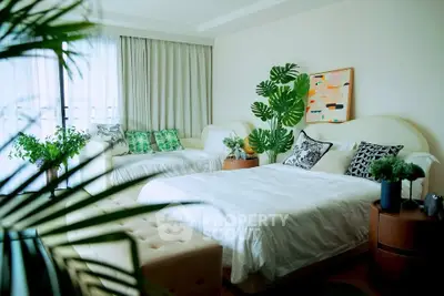 Spacious bedroom with elegant decor and lush greenery for a serene living experience.