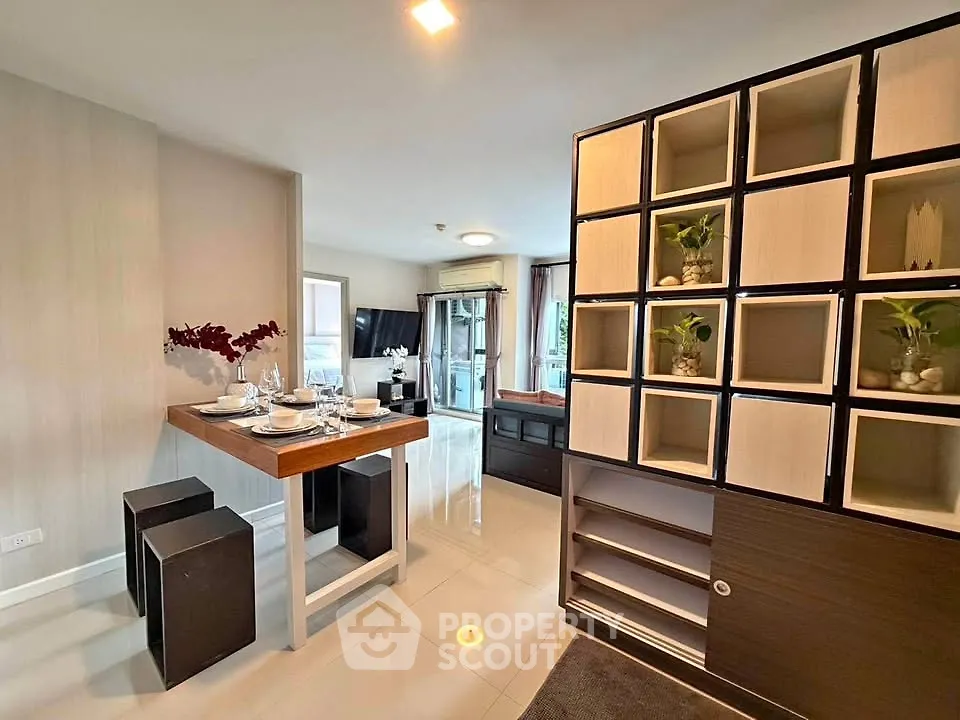 Modern open-plan living room with stylish dining area and decorative shelving