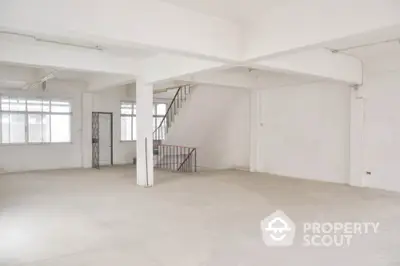 Spacious and bright open-plan loft space with high ceilings, large windows, and an industrial vibe, perfect for a creative studio or modern living.