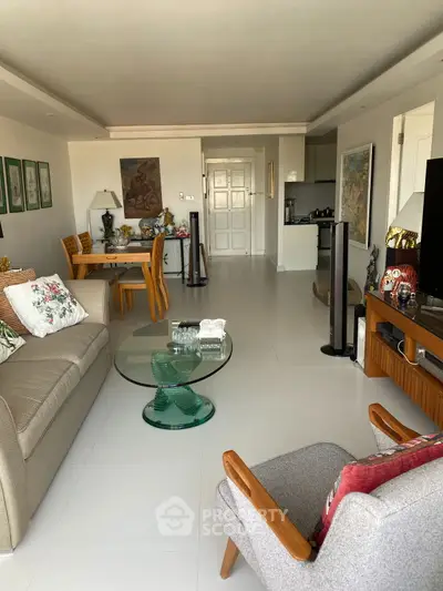 Spacious living room with modern decor and open layout, featuring stylish furniture and elegant design.