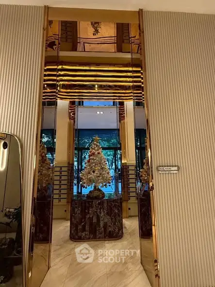 Luxurious building entrance with elegant decor and festive Christmas tree display.