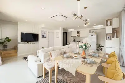 Spacious modern living room with open kitchen and elegant dining area, perfect for entertaining.