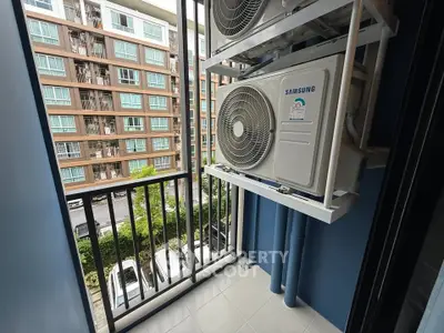 Modern apartment balcony with air conditioning units and city view.