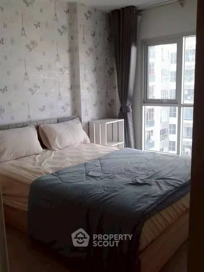 Cozy bedroom with large window and elegant wallpaper in modern apartment