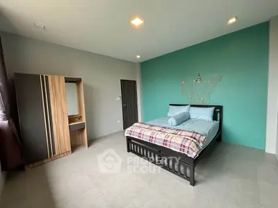 Spacious bedroom with modern decor and ample natural light