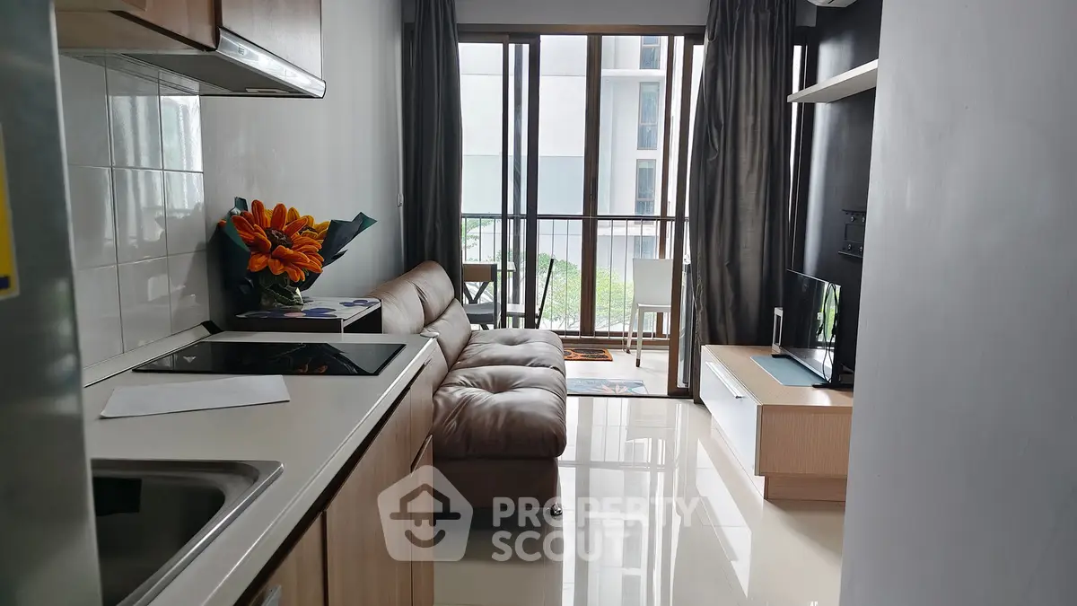 Modern living room with sleek furniture and large windows offering natural light and a cozy atmosphere.