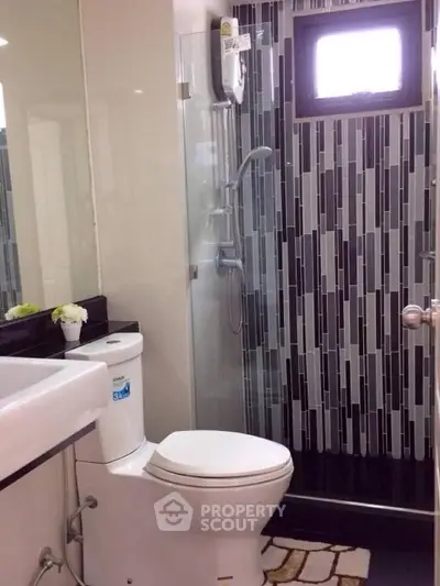 Modern bathroom with sleek shower and stylish tile design, perfect for contemporary living.