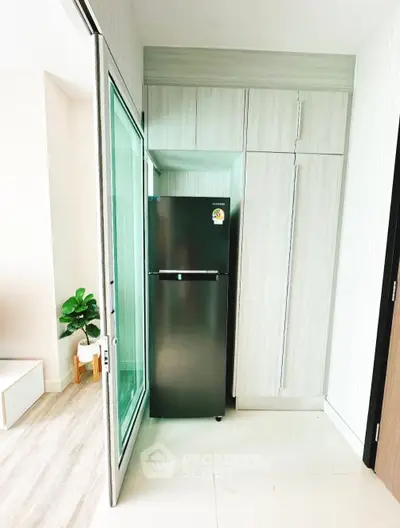 Modern kitchen with sleek black fridge and stylish cabinetry