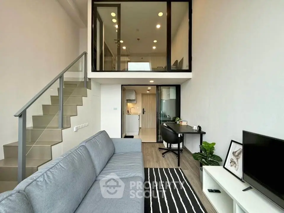 Modern loft apartment with mezzanine, stylish living area, and sleek staircase.