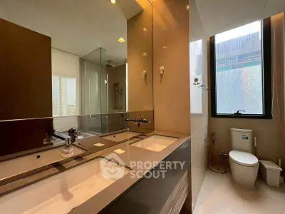 Luxurious modern bathroom with dual sinks and large window view.