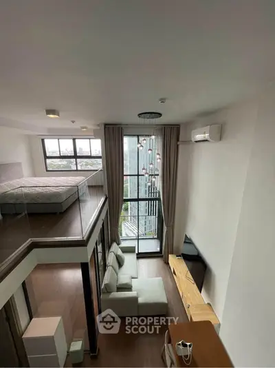 Modern loft apartment with high ceilings, large windows, and stylish interior design.