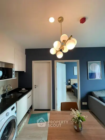 Modern apartment interior with stylish lighting and open kitchen layout